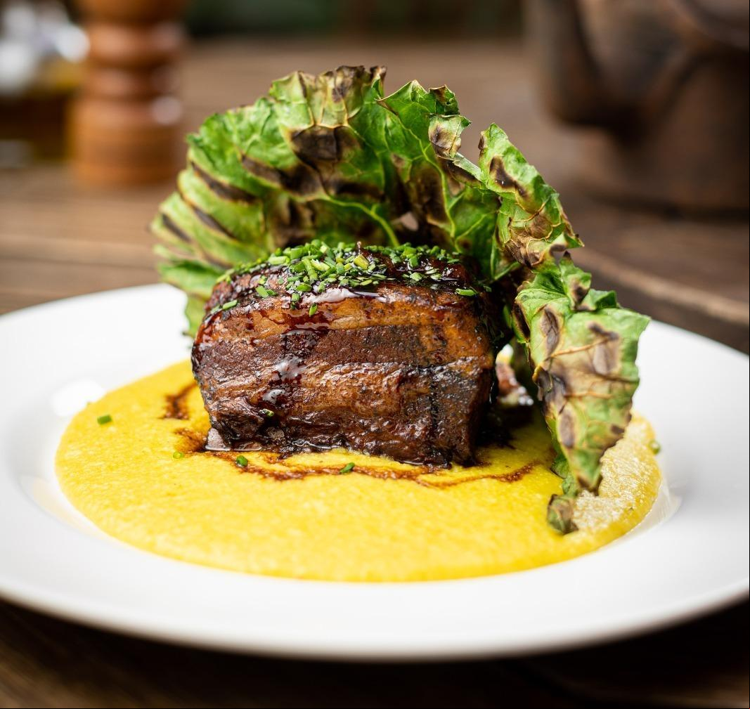 Costela de porco assada em baixa temperatura, com polenta cremosa e couve grelhada do restaurante O Italiano (Victor Schwaner /divulgação)